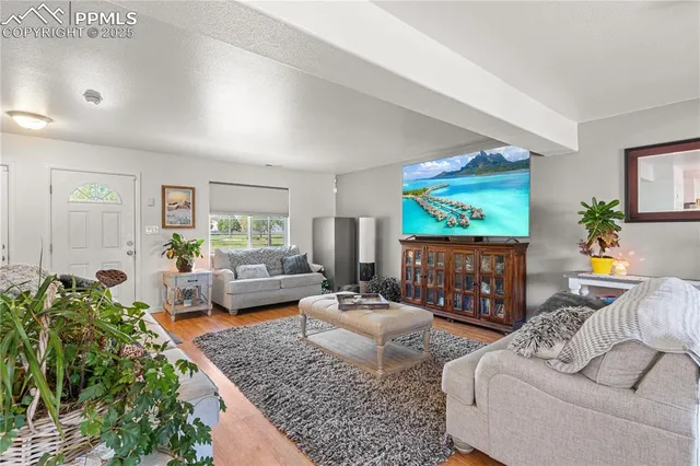 a living room with furniture and a flat screen tv