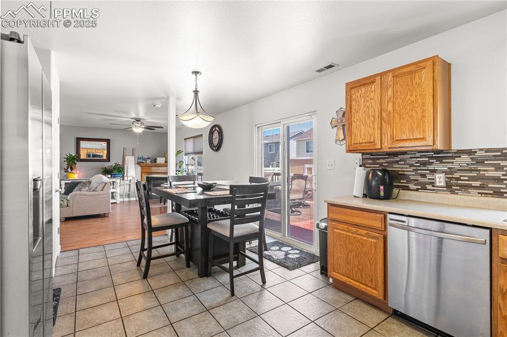 2000 Toronto Street Pueblo, CO 81004 - Photo 8 of 25 a kitchen with cabinets a sink dining table and chairs
