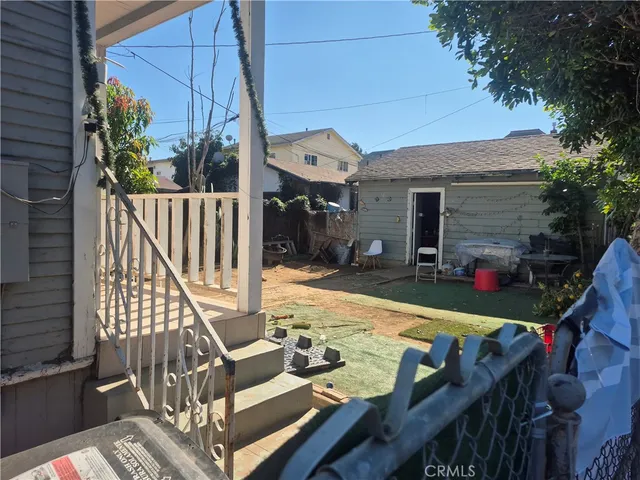 a view of deck with furniture and garden