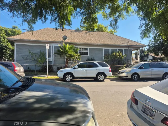 a view of a car parked in front of a house
