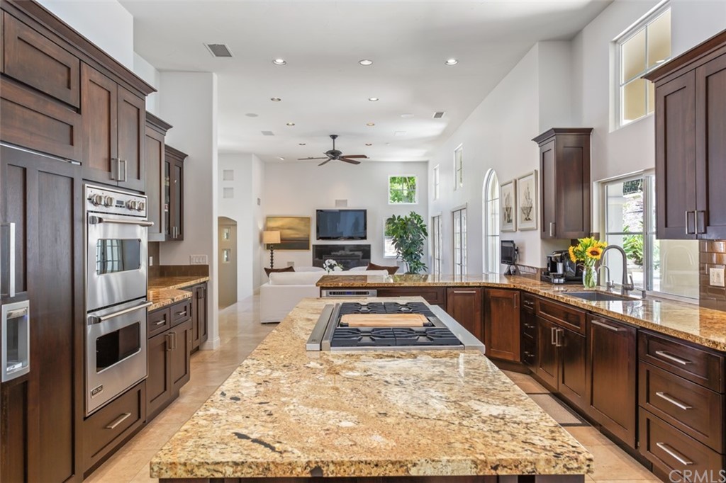 1785 North Kimbark Lane Orange, CA 92869 - Photo 11 of 35 a large kitchen with stainless steel appliances lots of counter space and wooden floor
