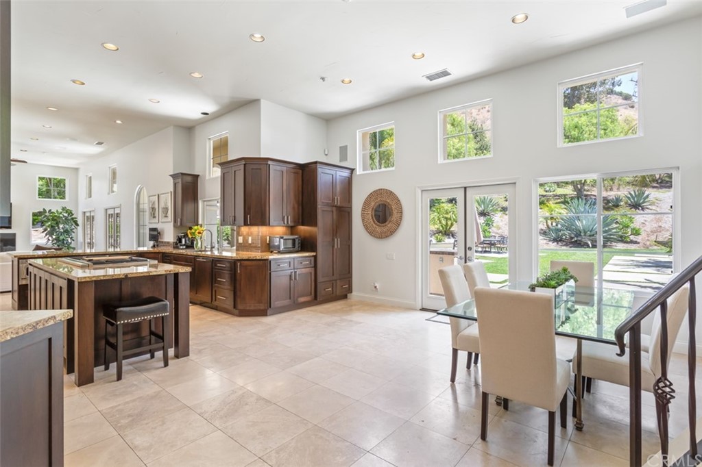 1785 North Kimbark Lane Orange, CA 92869 - Photo 12 of 35 a kitchen with stainless steel appliances a table and chairs in it