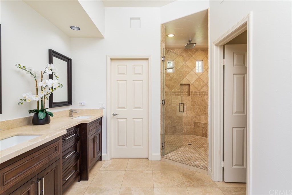 1785 North Kimbark Lane Orange, CA 92869 - Photo 18 of 35 a bathroom with a granite countertop shower sink and mirror