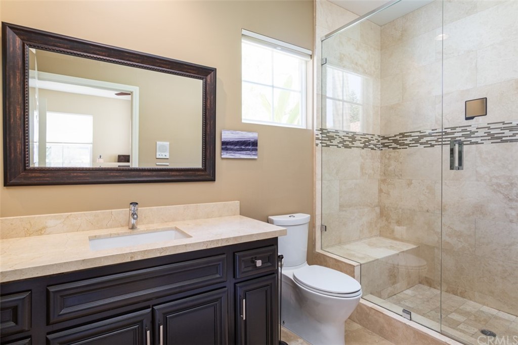 1785 North Kimbark Lane Orange, CA 92869 - Photo 30 of 35 a bathroom with a sink a toilet and a mirror