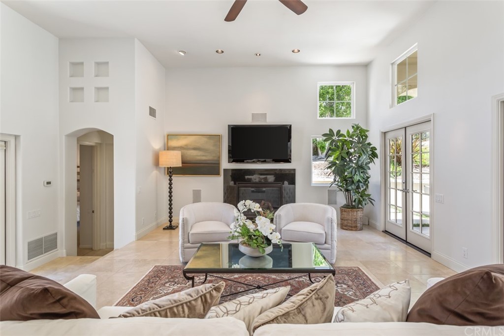 1785 North Kimbark Lane Orange, CA 92869 - Photo 9 of 35 a living room with furniture a flat screen tv and a large window