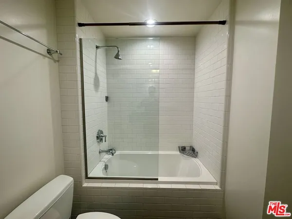 a bathroom with a tub and a shower