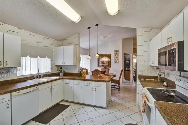 a kitchen with a table and refrigerator