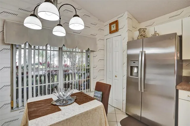 a bedroom with a bed television and a window