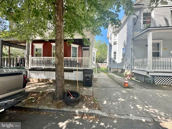a view of a patio with table and chairs and wooden fence