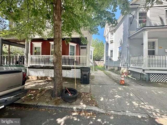 a view of a patio with table and chairs and wooden fence