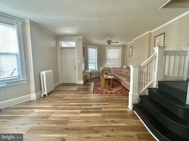 a view of a bedroom with wooden floor and stairs