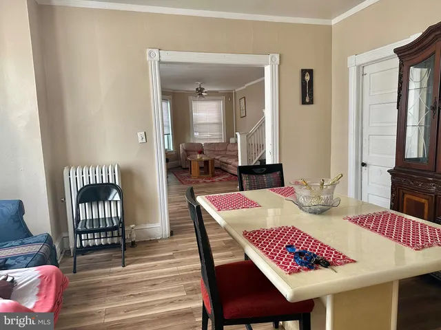 a dining room with furniture and wooden floor