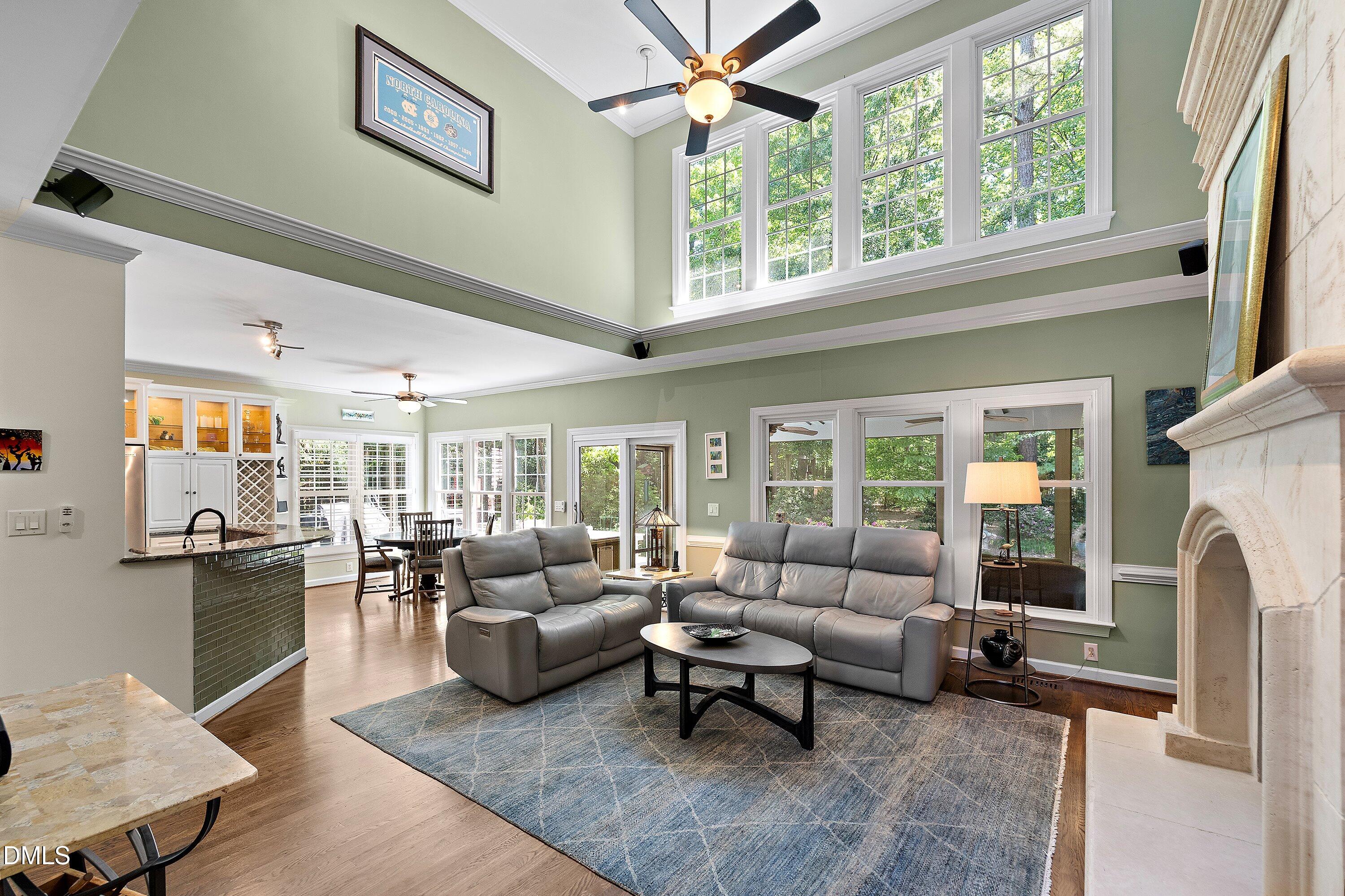 3608 Summer Leaf Court Raleigh, NC 27615 - Photo 11 of 63 a living room with furniture a fireplace and a large window