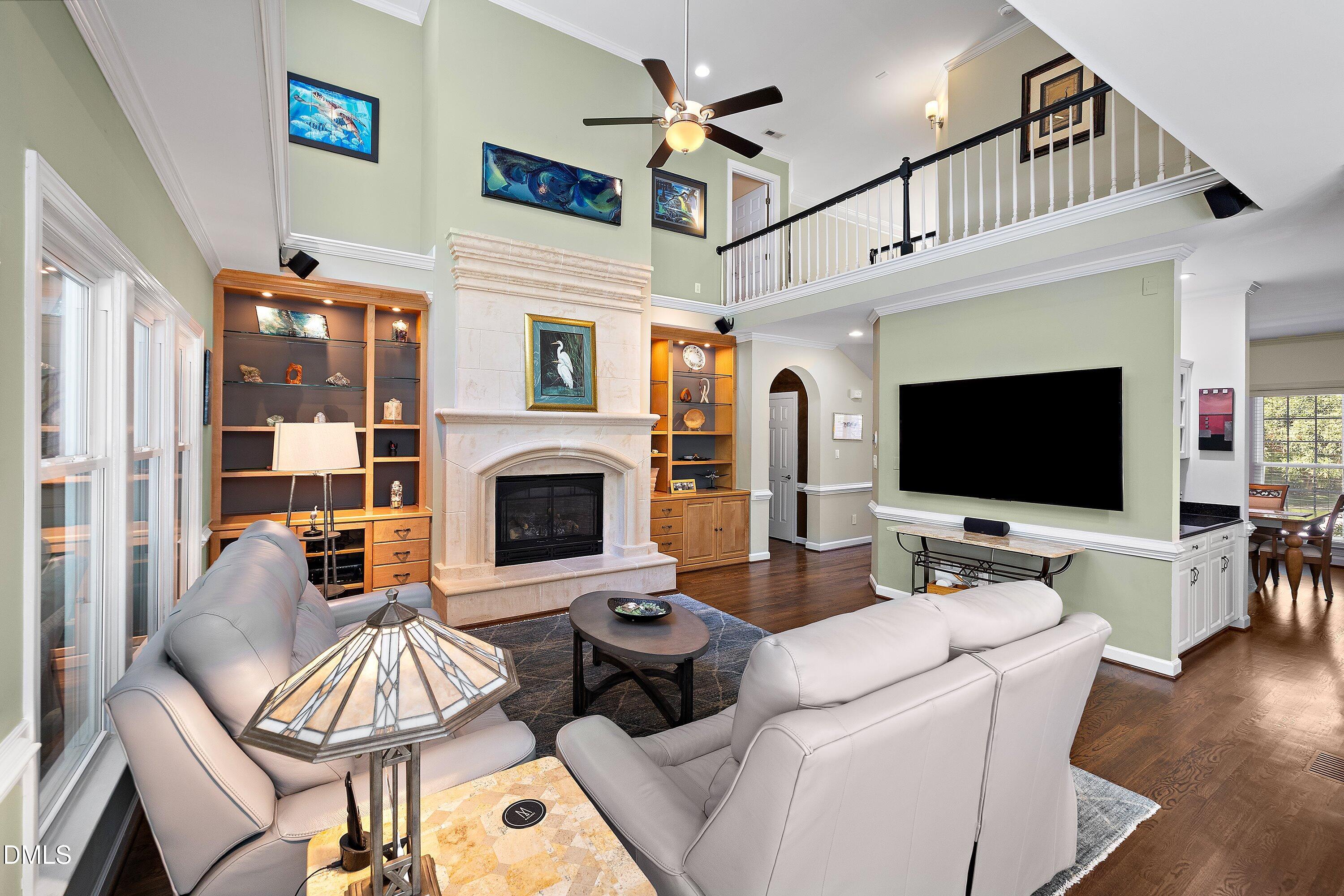 3608 Summer Leaf Court Raleigh, NC 27615 - Photo 14 of 63 a living room with furniture a flat screen tv and a fireplace