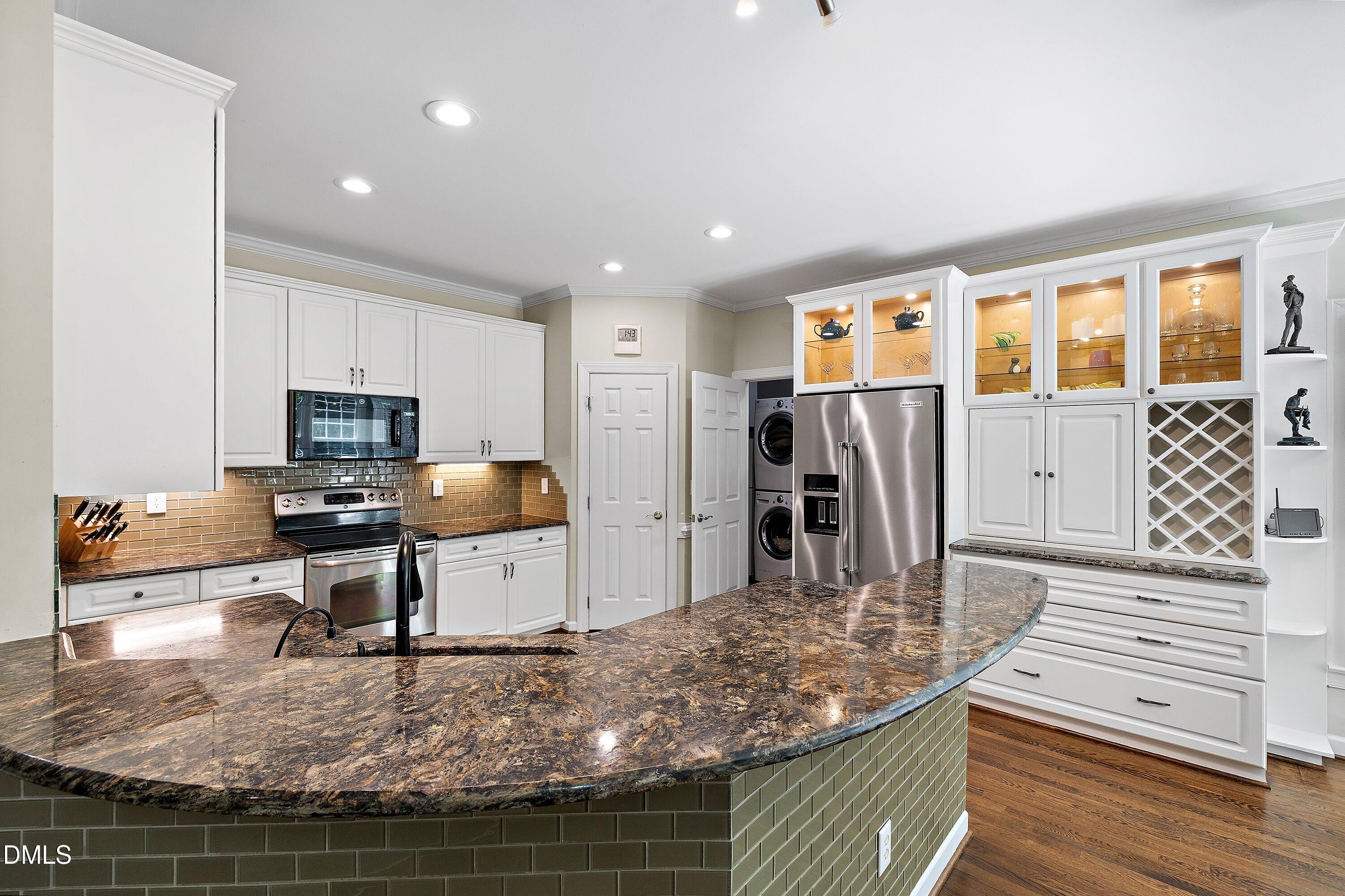 3608 Summer Leaf Court Raleigh, NC 27615 - Photo 19 of 63 a kitchen with stainless steel appliances granite countertop a sink stove and refrigerator