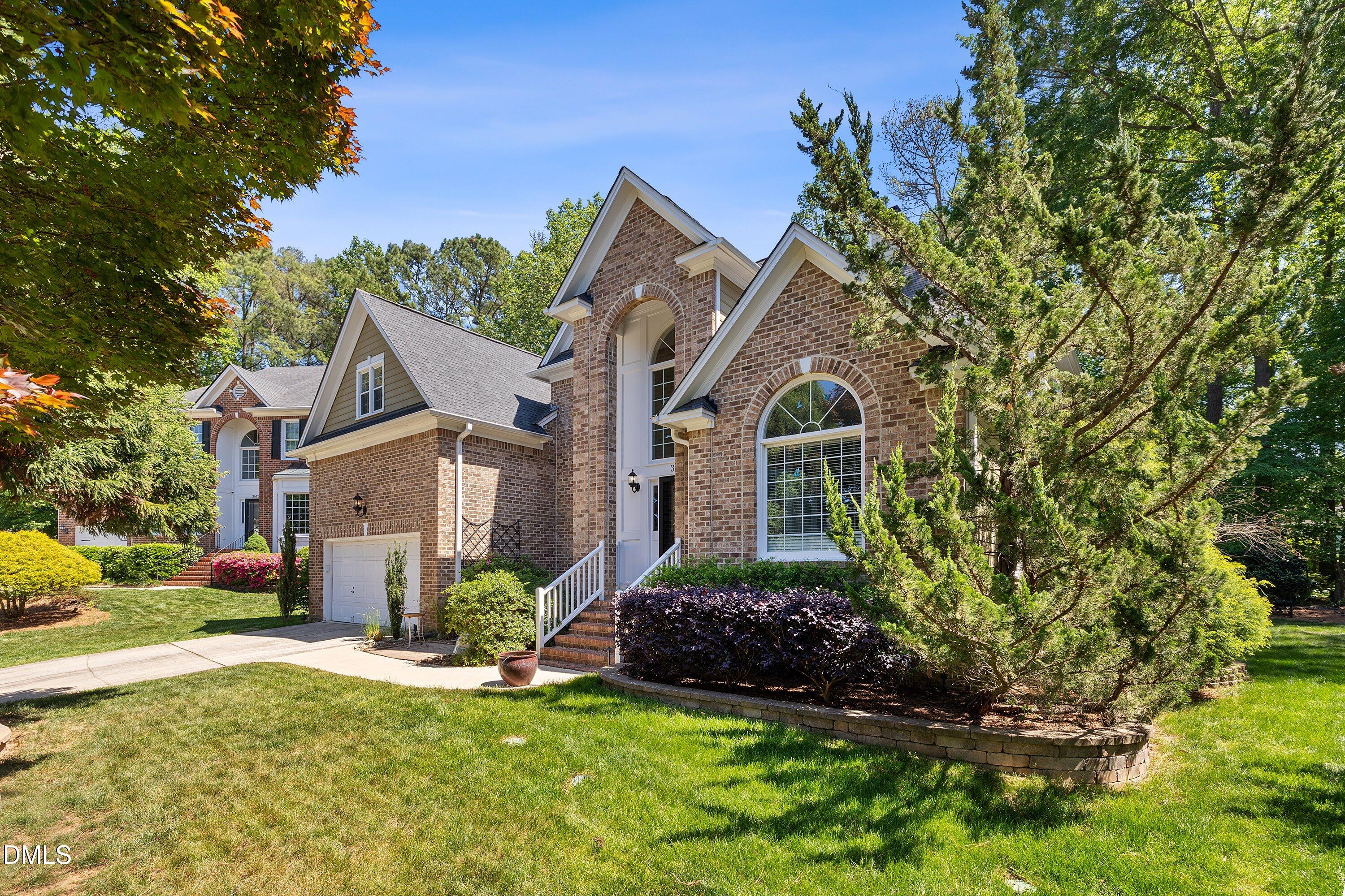 3608 Summer Leaf Court Raleigh, NC 27615 - Photo 2 of 63 a front view of a house with a garden