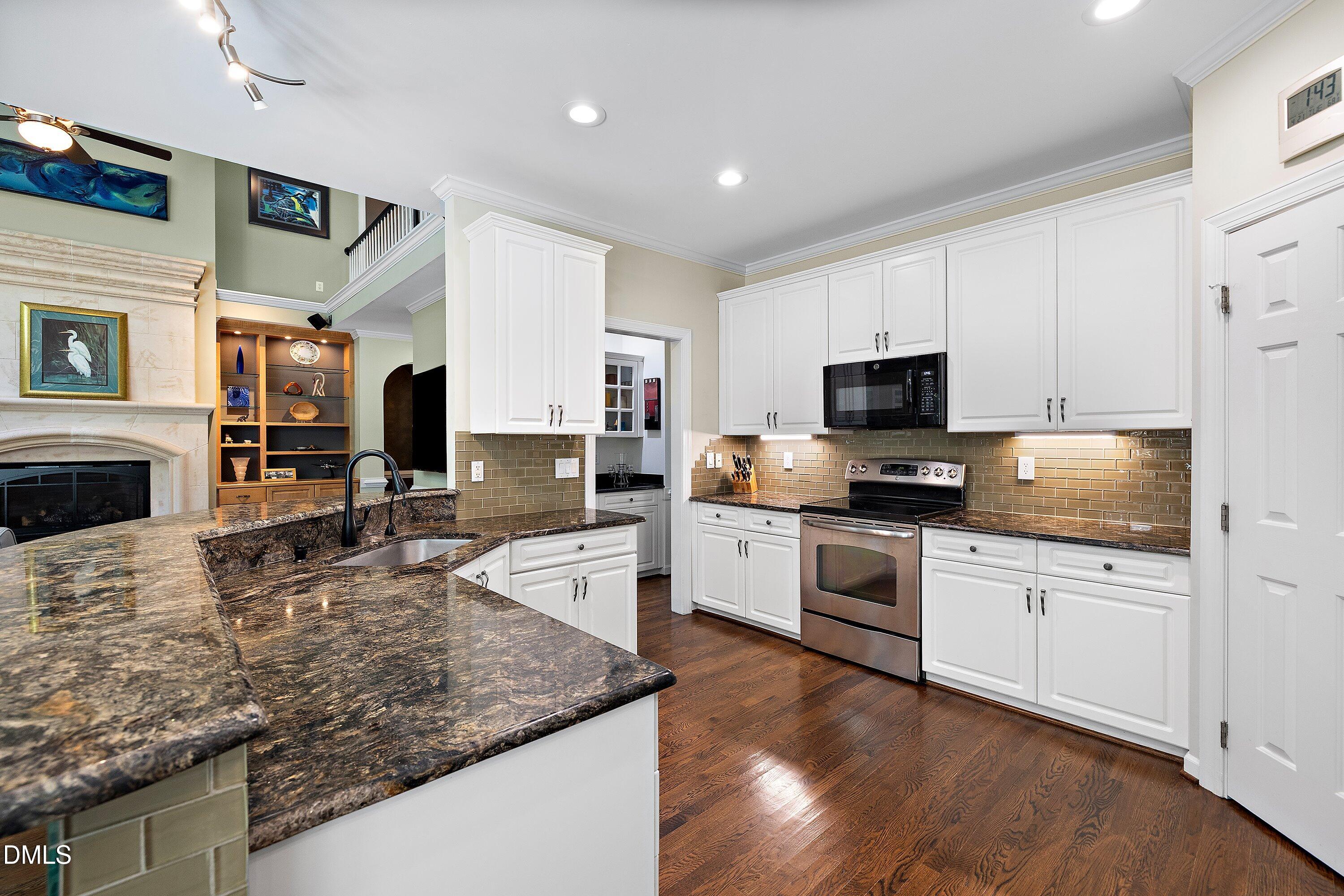 3608 Summer Leaf Court Raleigh, NC 27615 - Photo 22 of 63 a large kitchen with cabinets appliances and wooden floor