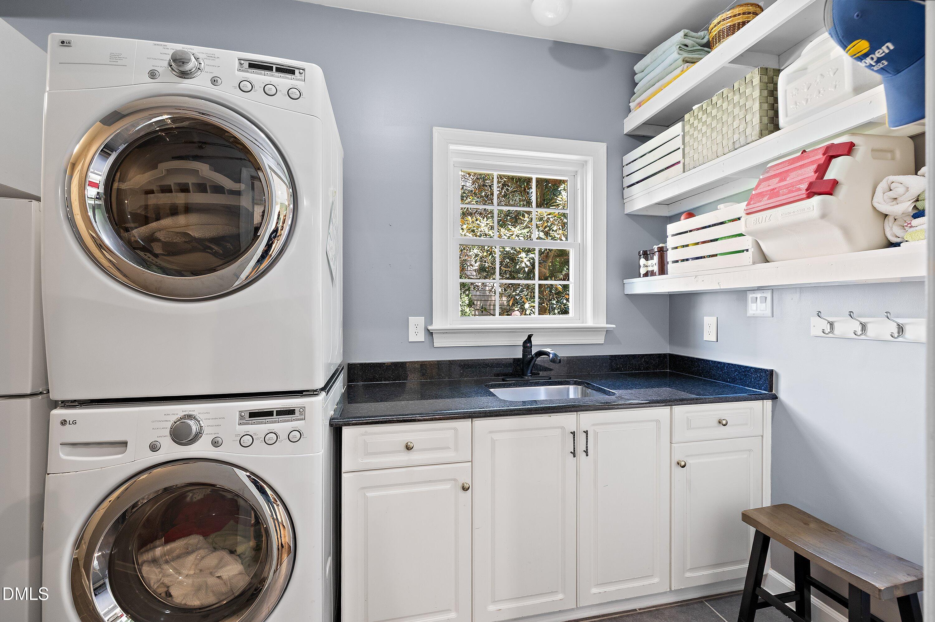 3608 Summer Leaf Court Raleigh, NC 27615 - Photo 29 of 63 a kitchen with granite countertop a sink a washer and dryer next to a window
