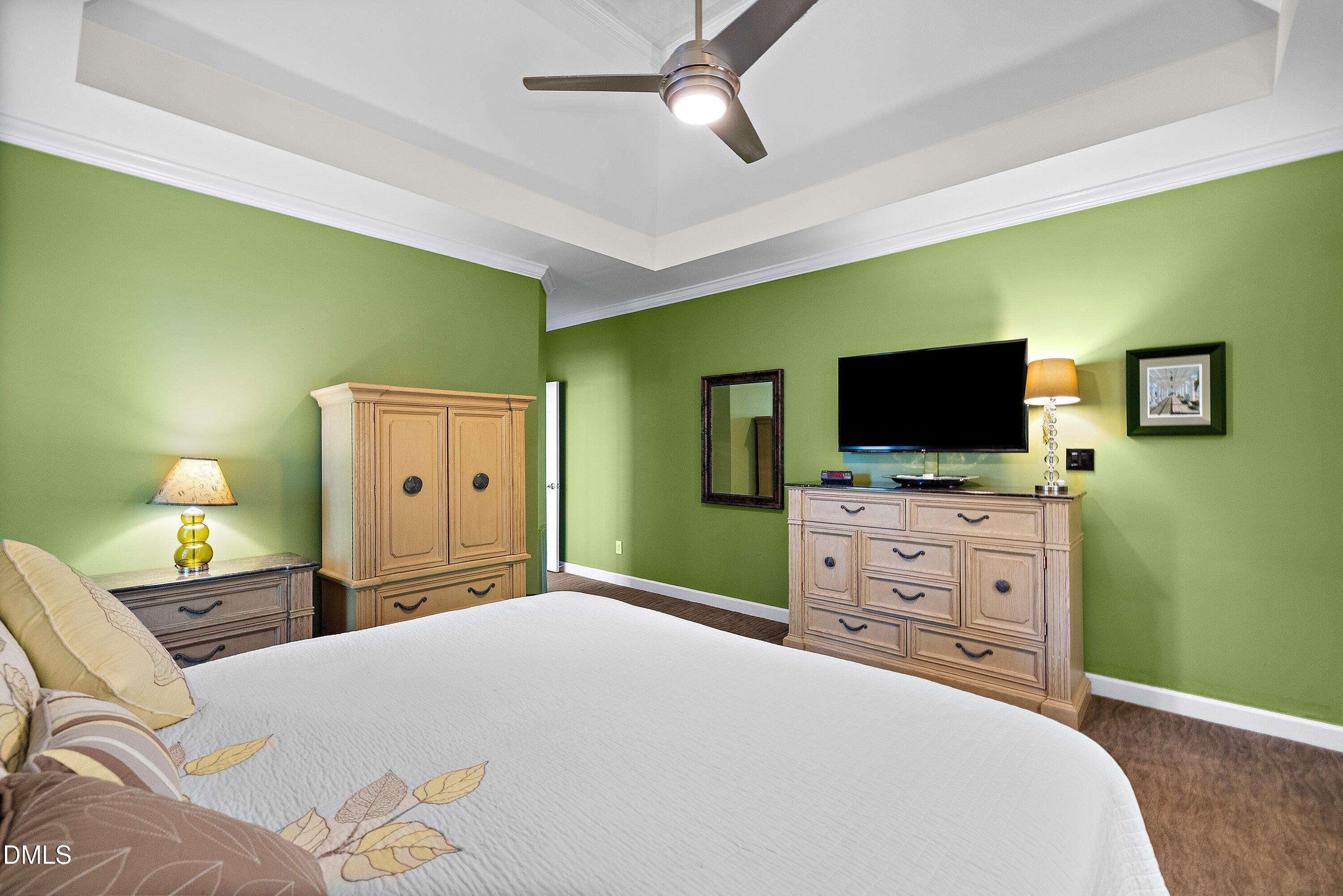 3608 Summer Leaf Court Raleigh, NC 27615 - Photo 33 of 63 a bedroom with a bed and a flat screen tv