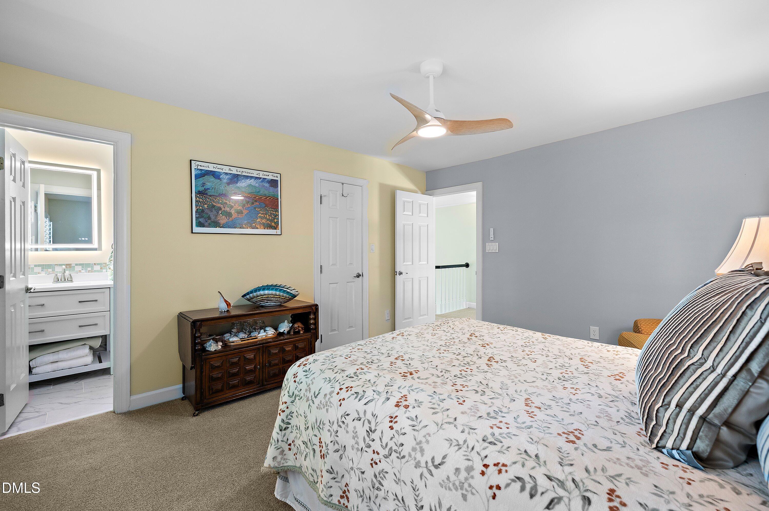 3608 Summer Leaf Court Raleigh, NC 27615 - Photo 39 of 63 a bedroom with a bed and a cabinets