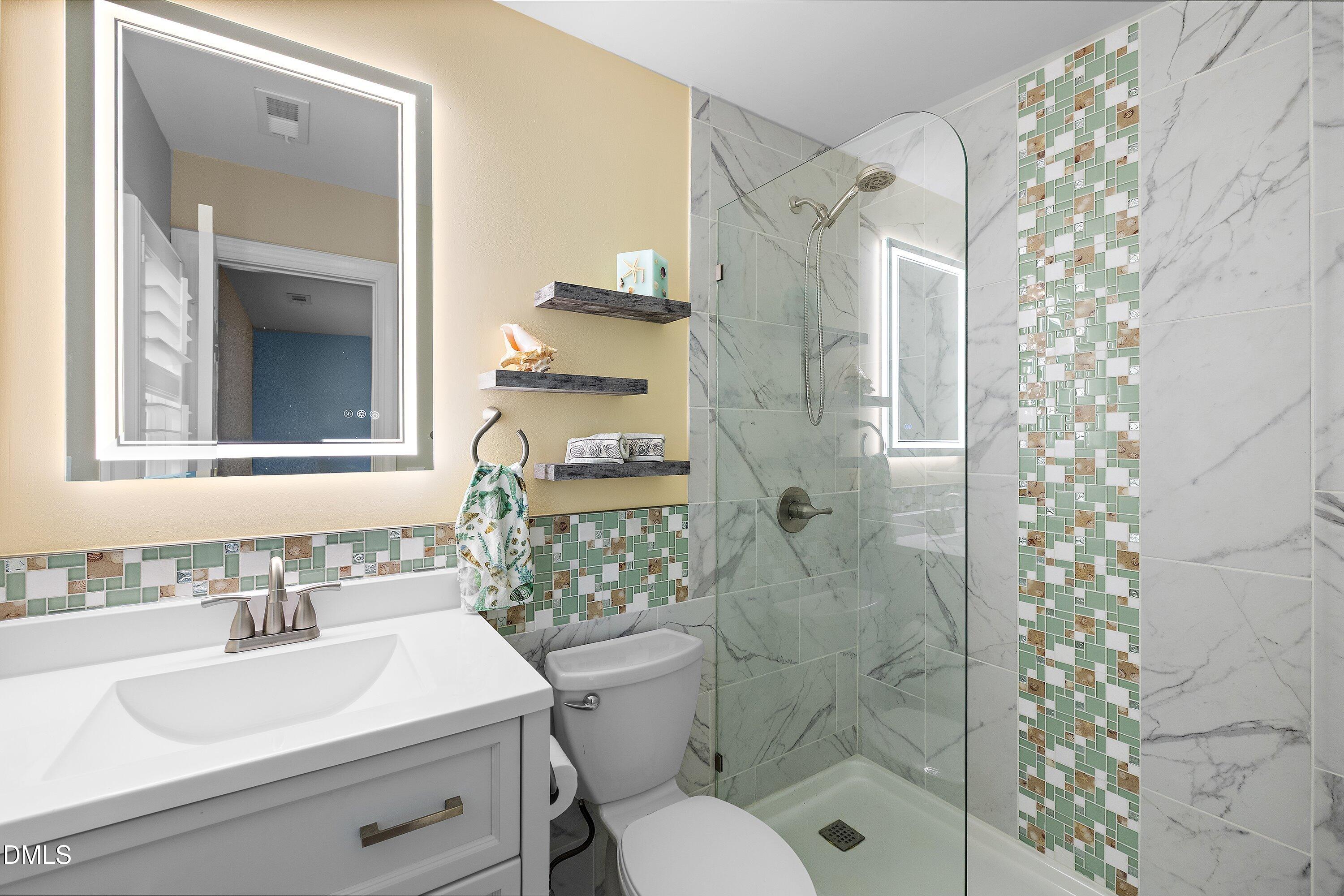 3608 Summer Leaf Court Raleigh, NC 27615 - Photo 40 of 63 a bathroom with a sink toilet and shower