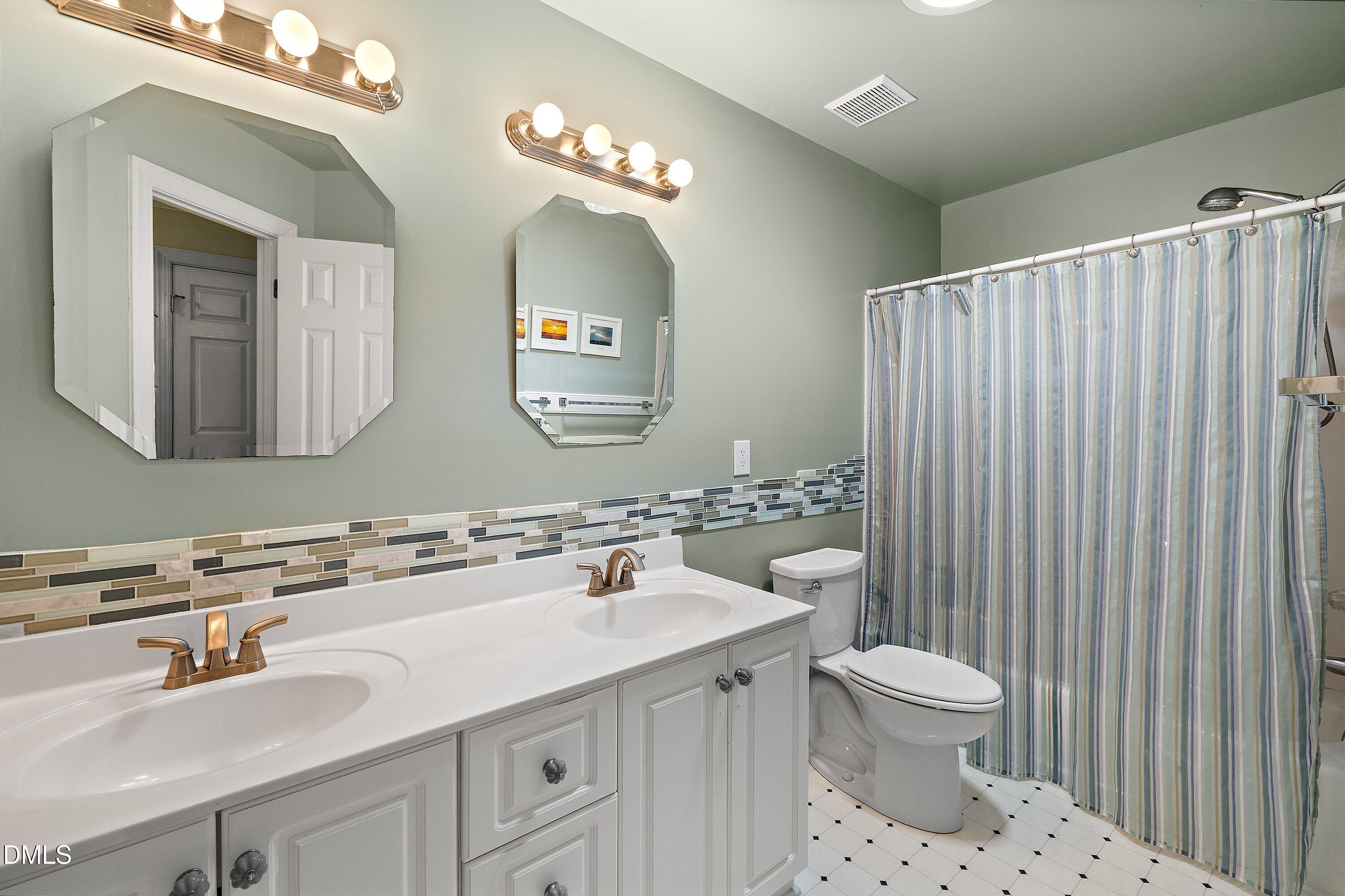 3608 Summer Leaf Court Raleigh, NC 27615 - Photo 46 of 63 a bathroom with a sink toilet and mirror