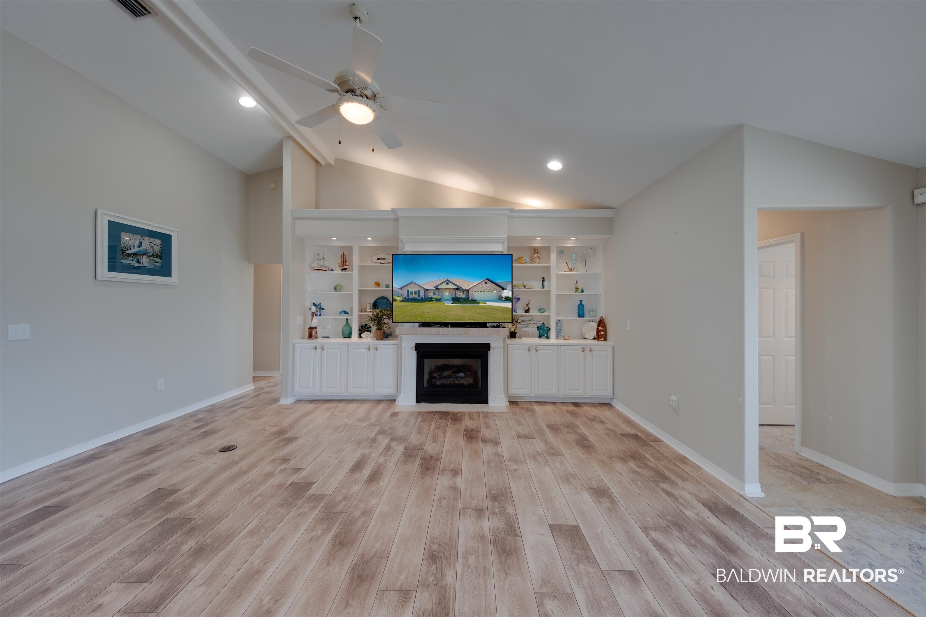 9462 Lakeview Drive Foley, AL 36535 - Photo 12 of 50 Unfurnished living room with vaulted ceiling, built in features, light hardwood / wood-style flooring, and ceiling fan