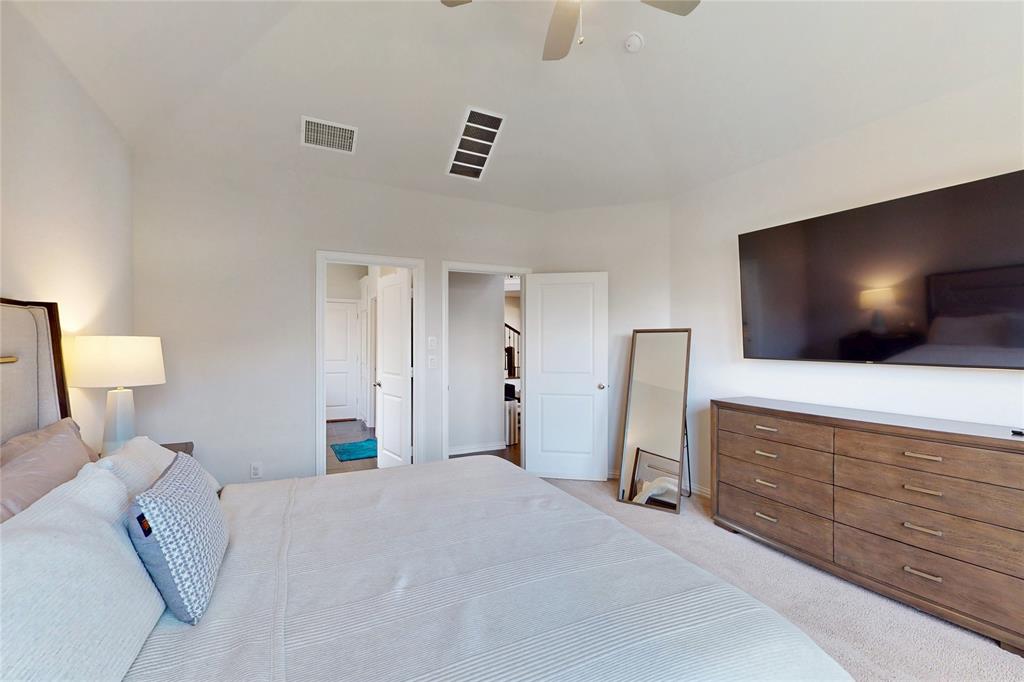 1997 Kieva Place Allen, TX 75013 - Photo 15 of 40 Bedroom featuring a ceiling fan, lofted ceiling, and light carpet