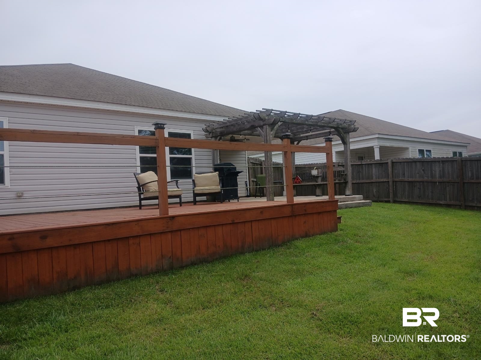 17431 Harding Drive Foley, AL 36535 - Photo 19 of 24 Back of house featuring a wooden deck, a yard, and a pergola