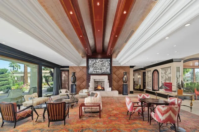 a living room with furniture and a floor to ceiling window