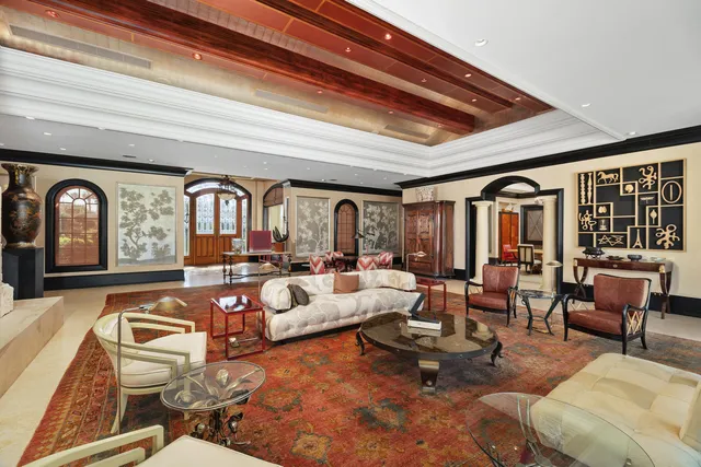 a bedroom with furniture and large windows