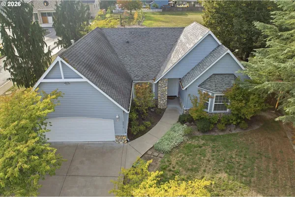 a aerial view of a house with a yard