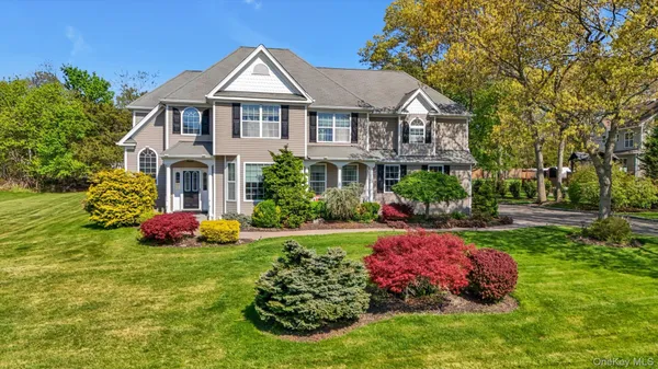 a front view of house with yard and green space