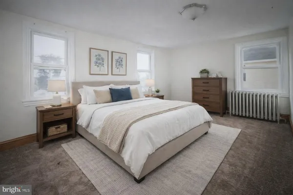 a bedroom with a bed and a tv