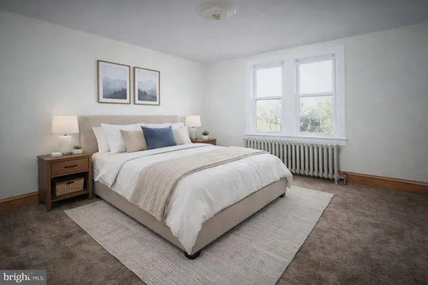 a view of a bedroom with a bed and a window