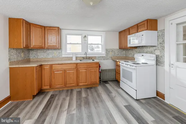 a kitchen with a sink stove and cabinets