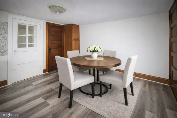 a view of a dining room with furniture and wooden floor