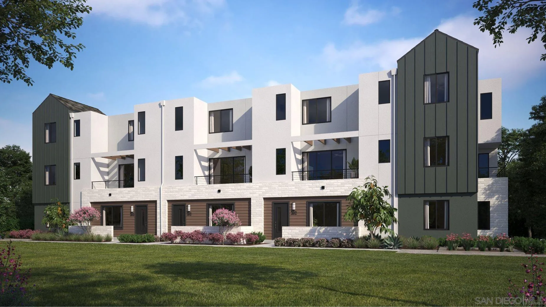 a front view of building with yard and traffic signal