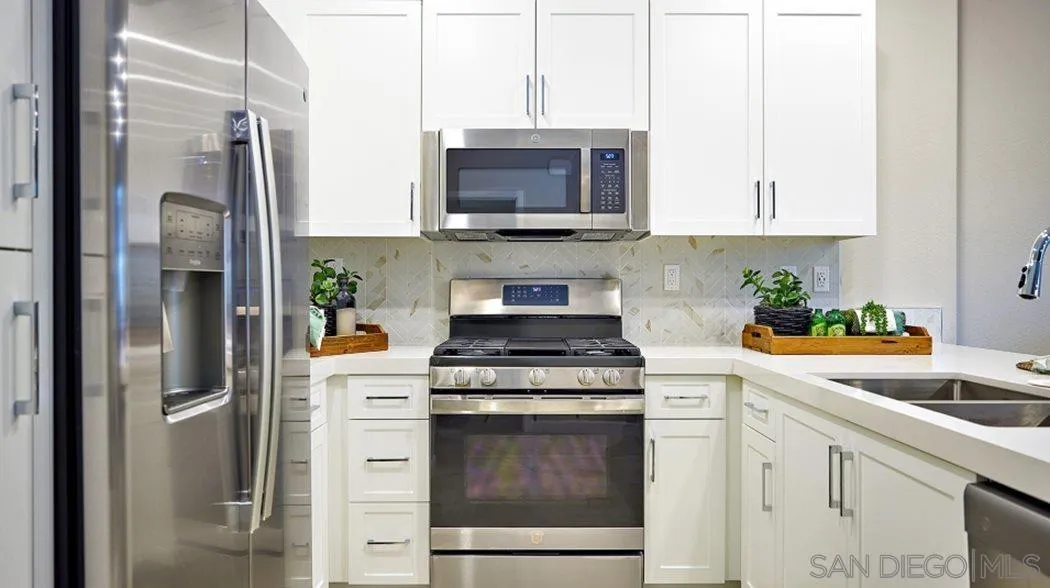 2139 Acara Circle San Diego, CA 92154 - Photo 9 of 10 a kitchen with stainless steel appliances granite countertop a refrigerator sink and stove