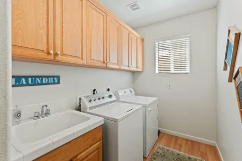 a utility room with sink dryer and washer