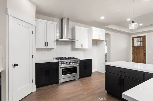 a kitchen with stainless steel appliances granite countertop a stove a refrigerator and a sink