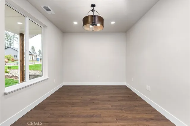 a room with wooden floor and window