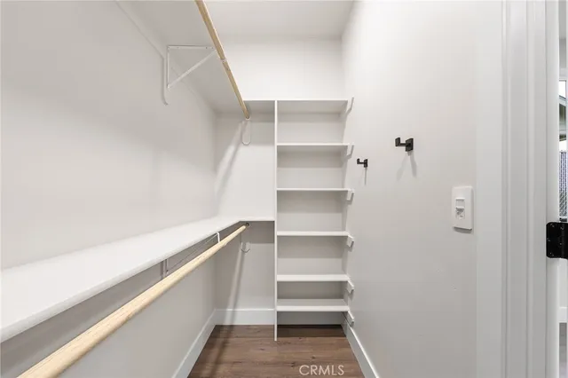 a view of walk in closet with empty racks