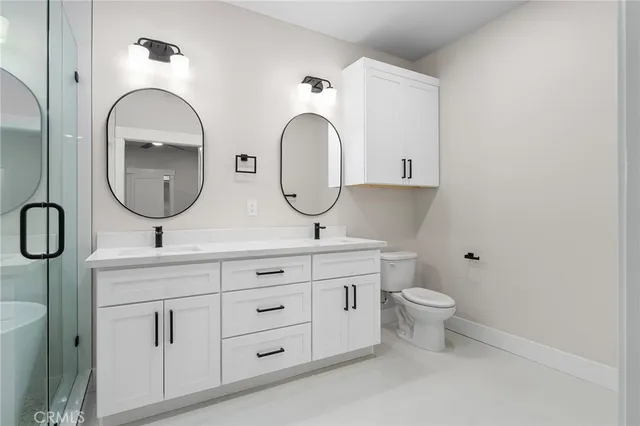 a bathroom with 2 sink and a mirror