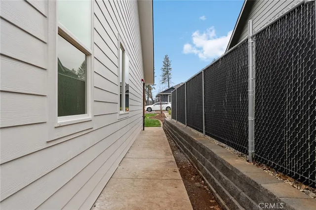 a view of a house with backyard and a lake view