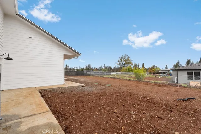 a view of a house with a yard and potted plants