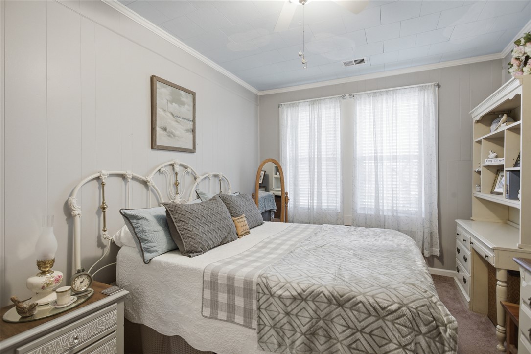 175 Burkett Road Seneca, SC 29672 - Photo 13 of 47 This cozy bedroom features paneling and crown molding, creating a serene and inviting atmosphere.