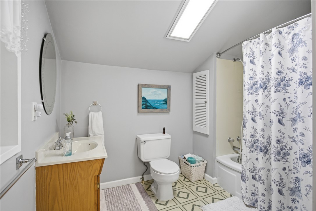 175 Burkett Road Seneca, SC 29672 - Photo 22 of 47 This bright bathroom features a skylight, a classic tub, and charming flooring.