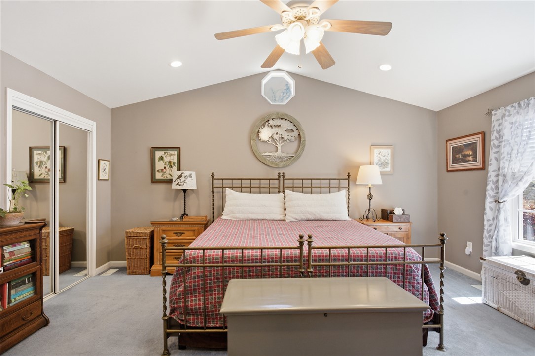 175 Burkett Road Seneca, SC 29672 - Photo 27 of 47 This inviting bedroom features vaulted ceilings, recessed lighting, and a mirrored closet, creating an airy and functional space.
