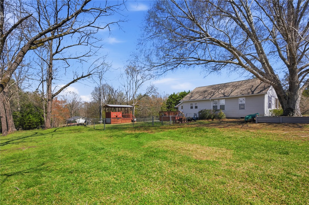 175 Burkett Road Seneca, SC 29672 - Photo 34 of 47 Expansive green lawn surrounds this home, offering abundant outdoor space and a tranquil setting.